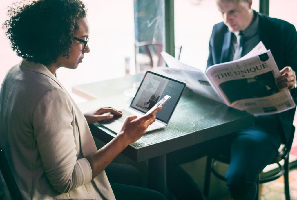 business professionals reading news and using smartphone