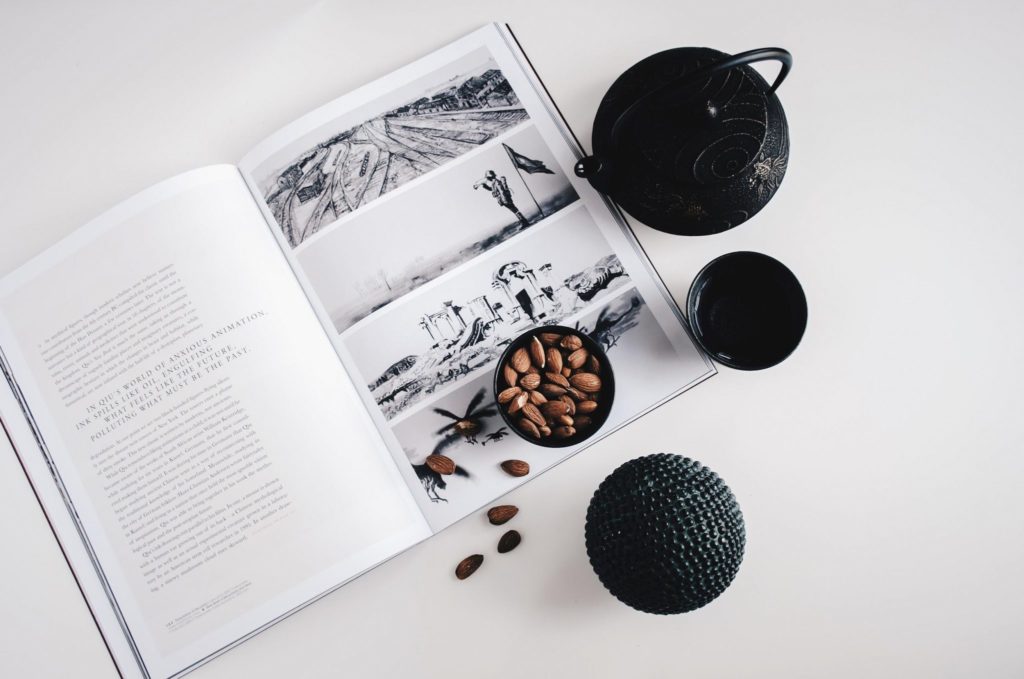 Open book with almonds and tea set