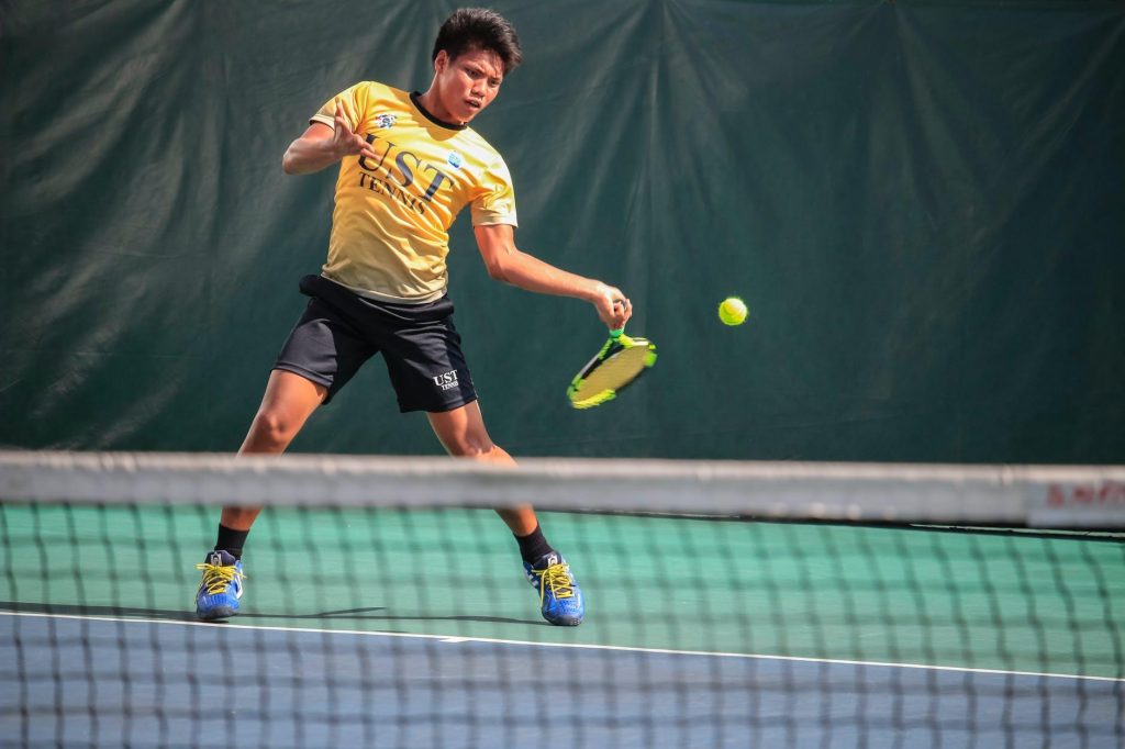 Young male tennis player hitting a forehand shot
