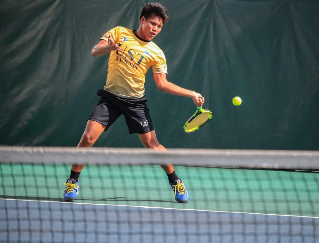 Young male tennis player hitting a forehand shot