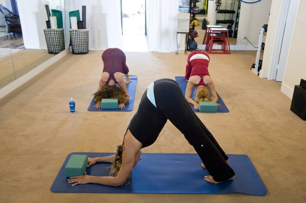 Group of women practising yoga in a fitness studio