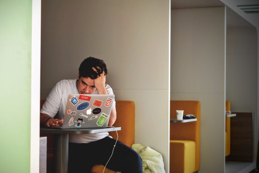 stressed-man-working-on-laptop-at-desk