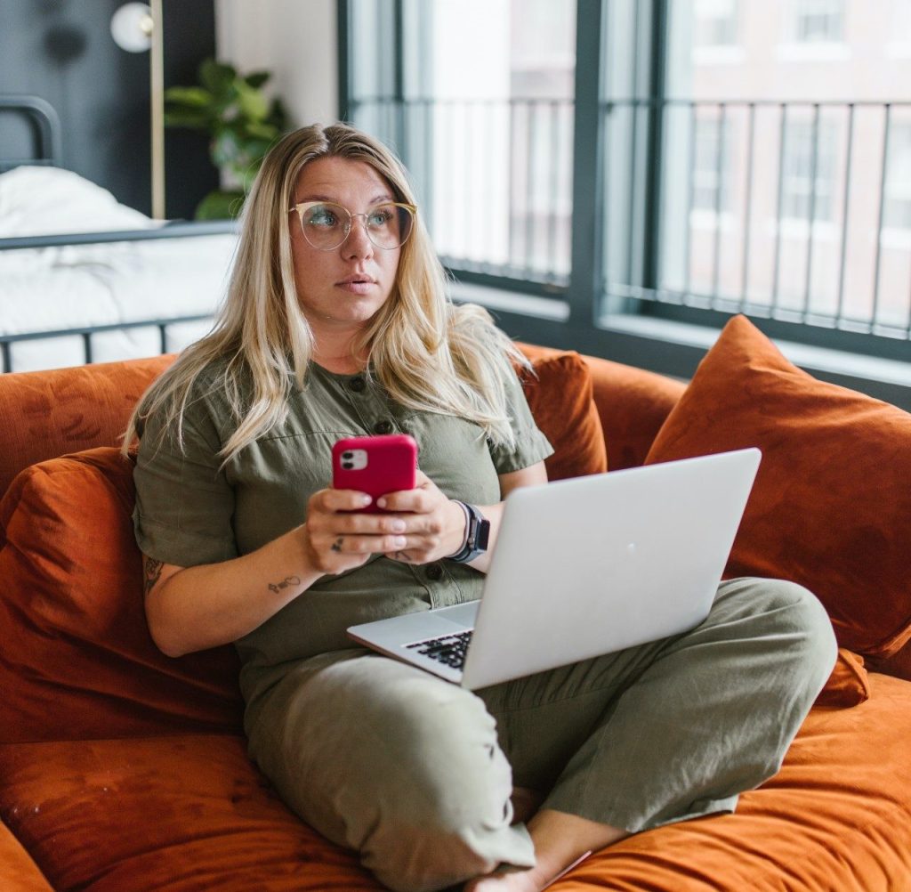 Woman procrastinating on sofa